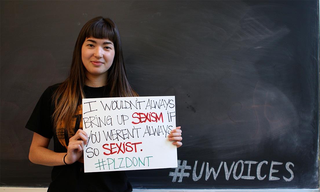 Student holding sign addressing sexism