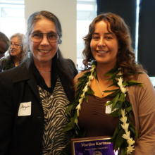 Retired professor Angela Ginorio standing next to GWSS Alumni Award recipient Martina Kartman. Martina is holding the Alumni Award plaque in her hands.  