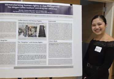 Marielle Marcaida, a GWSS PhD student, stands smiling beside her research poster at the 2025 UW Labor Studies Awards Celebration.