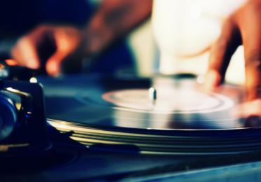Closeup of a hand on a turntable. 