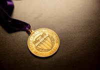 University of Washington medal on a purple ribbon with a solid grey background