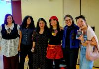 Speakers and a graduate student pose together at a GWSS book launch, holding a copy of Navigating Academia as a Transnational Scholar from the Global South.