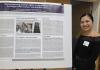 Marielle Marcaida, a GWSS PhD student, stands smiling beside her research poster at the 2025 UW Labor Studies Awards Celebration.