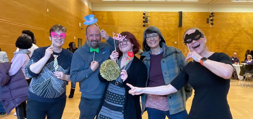 Two photos with people holding photo props within a purple banner reading "Distinguished Staff Awards 2026"
