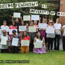 Students with who needs feminism campaign posters