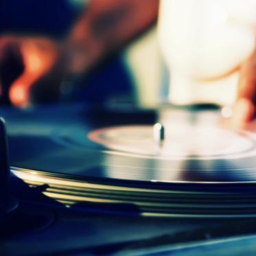 Closeup of a hand on a turntable.