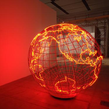 Photograph of an art installation of the globe. Composed of stainless steel and neon glass tubes.
